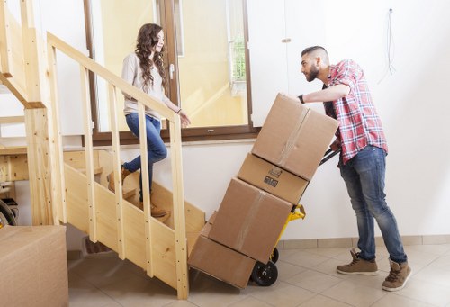 Local moving team loading boxes and furniture into a van